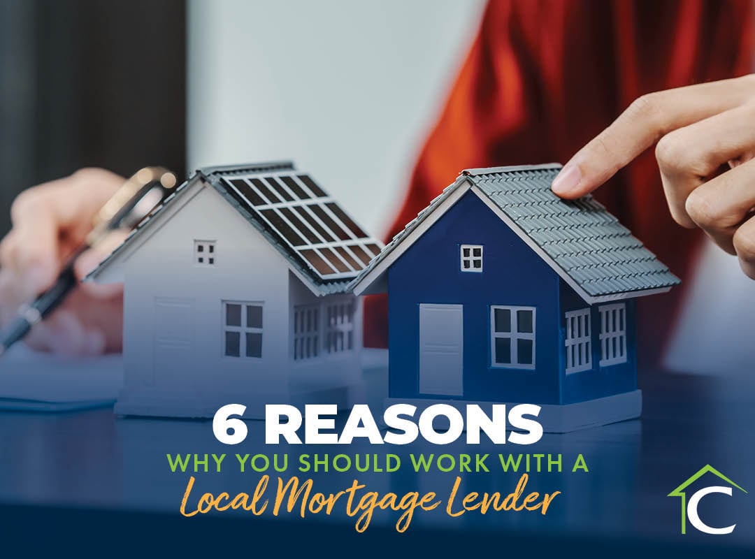 6 Reasons Why You Should Work With A Local Mortgage Lender text on top of background of two miniature houses on a desk.